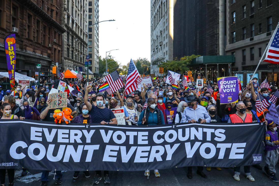 Marchers on 7th Avenue in Midtown, with an Every Vote Counts banner